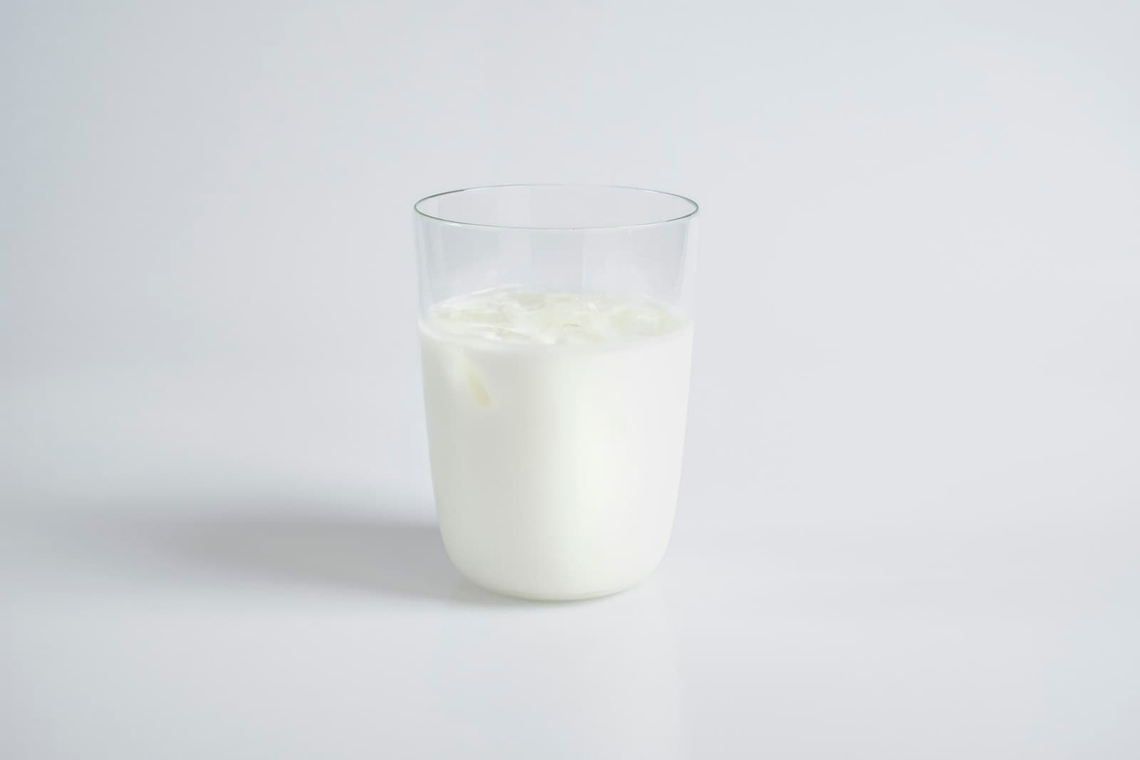 A glass of milk on a pale surface
