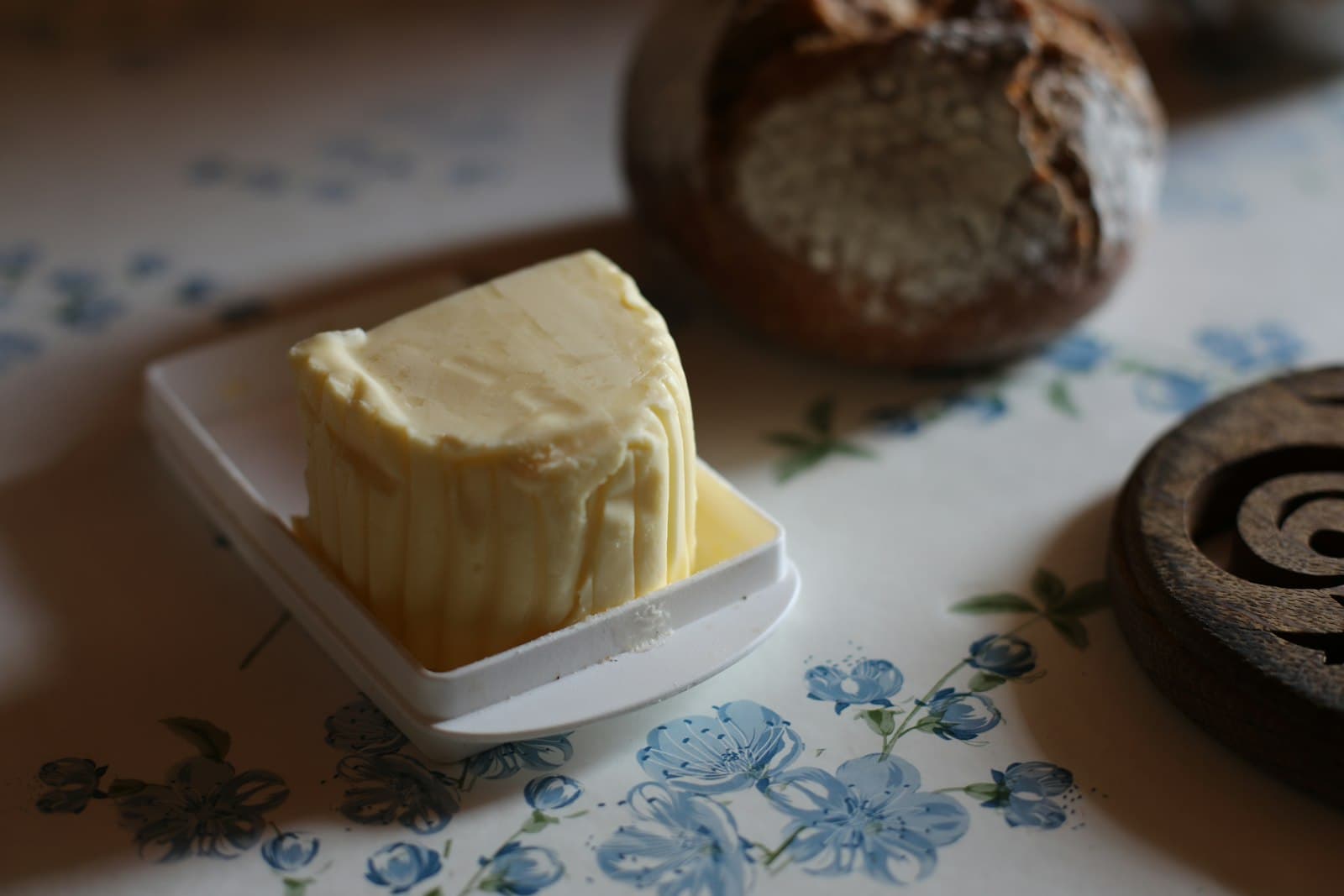A block of butter on a small decorative plate